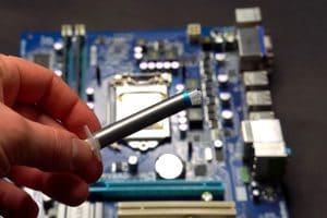 Drawing thermal paste on the computer processor. Installing a cooling system on a CPU processor