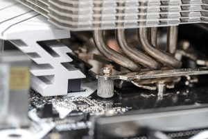 Macro shot of a modern desktop motherboard with a heatsink mounted on the CPU on the socket LGA.