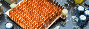 Close up view of copper heat sink or radiator on computer motherboard. Close up and side angle view.