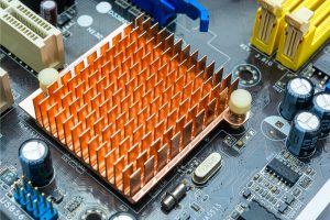 Close up view of copper heat sink or radiator on computer motherboard. Close up and side angle view.