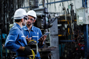 Two men engineer talking in modern factory. Production line mach