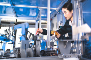 Female Engineers Maintenance Robot Arm at Lab. She are in a High Tech Research Laboratory with Modern Equipment. Technology and Innovation Concept.Professional Japanese Development Engineer is Testing an Artificial Intelligence.start up concept.