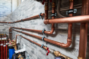 copper pipes of a private house autonomous heating system in boiler room. Plumbing services