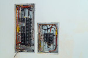 Electrical voltage switchboard box with wires with circuit breakers.