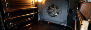 Oven interior with forced draft fan and lighting.