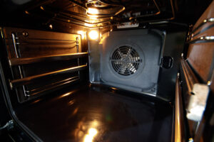 Oven interior with forced draft fan and lighting.