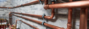 copper pipes of a private house autonomous heating system in boiler room. Plumbing services